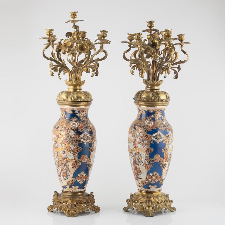 A pair of gilt-brass and satsuma ware seven-light candelabra, the porcelain Meiji period (1868-1912).