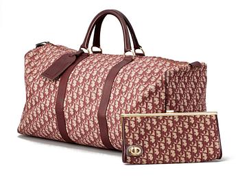 534. A red monogram canvas weekendbag and clutch by Christian Dior.