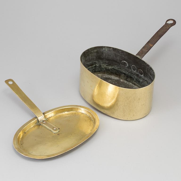 A BRASS AND CAST IRON SAUCEPAN AND COVER, 18th century.