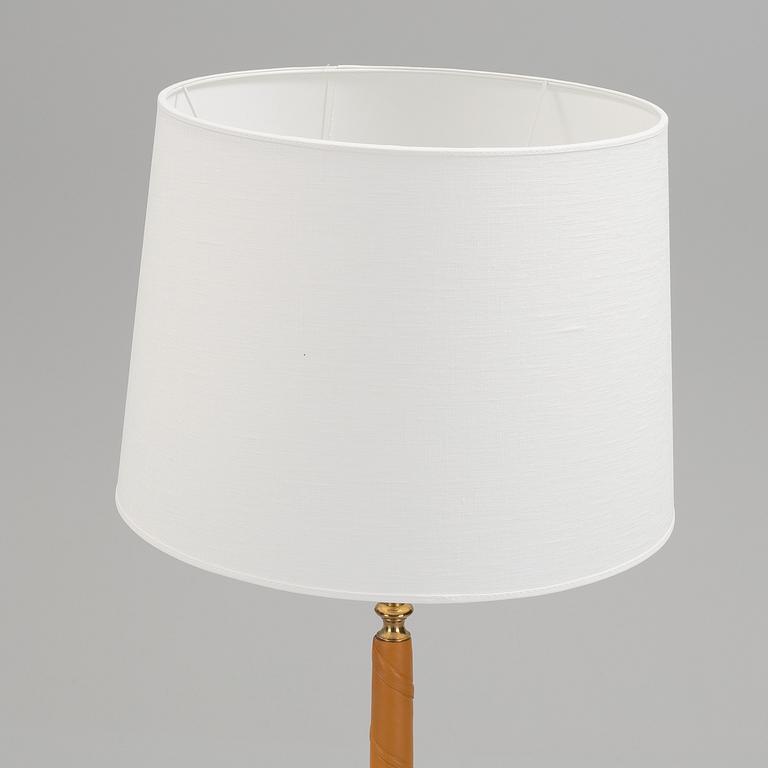 A 1960s brass and leather floor light.