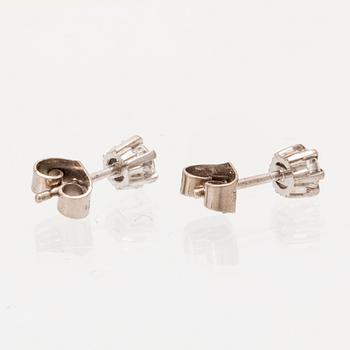 A pair of 18K white gold earrings set with round brilliant cut diamonds.