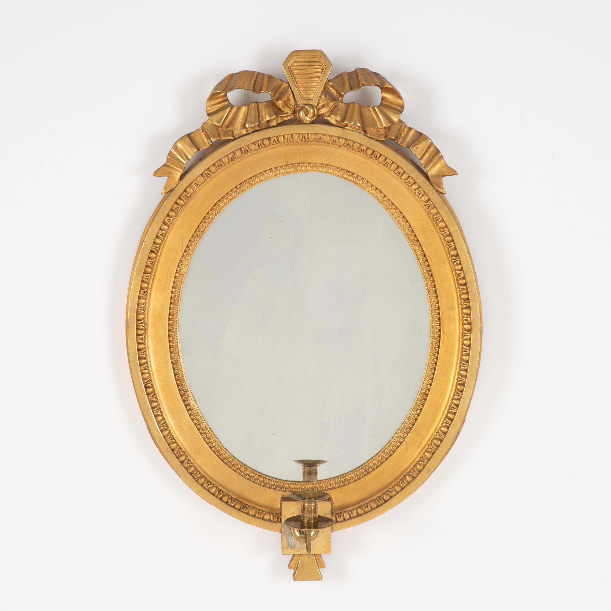 A Gustavian giltwood one-branch girandole mirror, Stockholm, late 18th century.