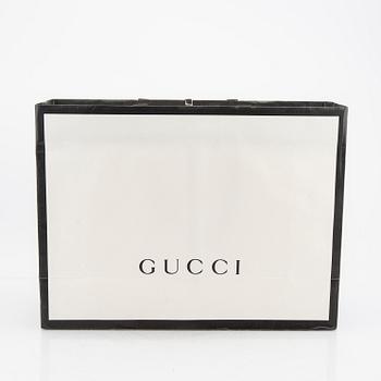 A Gucci diaper bag.