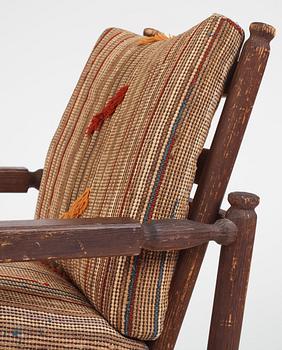 Axel Einar Hjorth, a pair of stained pine "Sandhamn" easy chairs, Nordiska Kompaniet, Sweden, 1929.