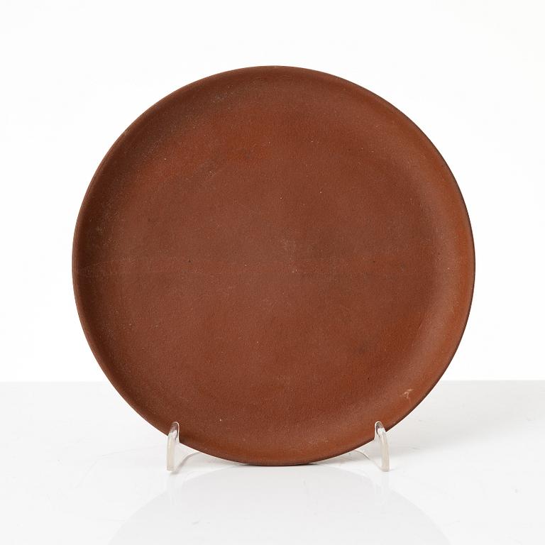 A six part red yixing Gongfu set; teapot, four cups and a tray, China, 1980s.