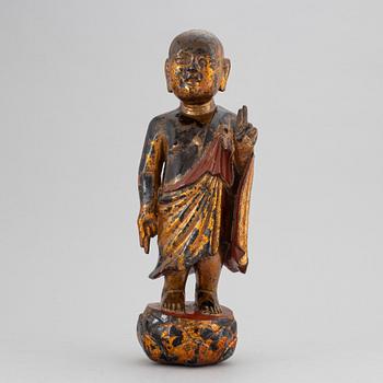 A Chinese wood gilt and lacquer sculpture of a boy, 20th Century.