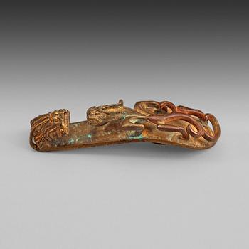 99. A gilt bronze belt hook, presumably Han dynasty (206 BC-220 AD).