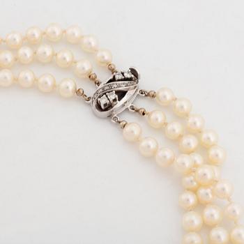 Three strand cultured pearl necklace, clasp with diamonds.