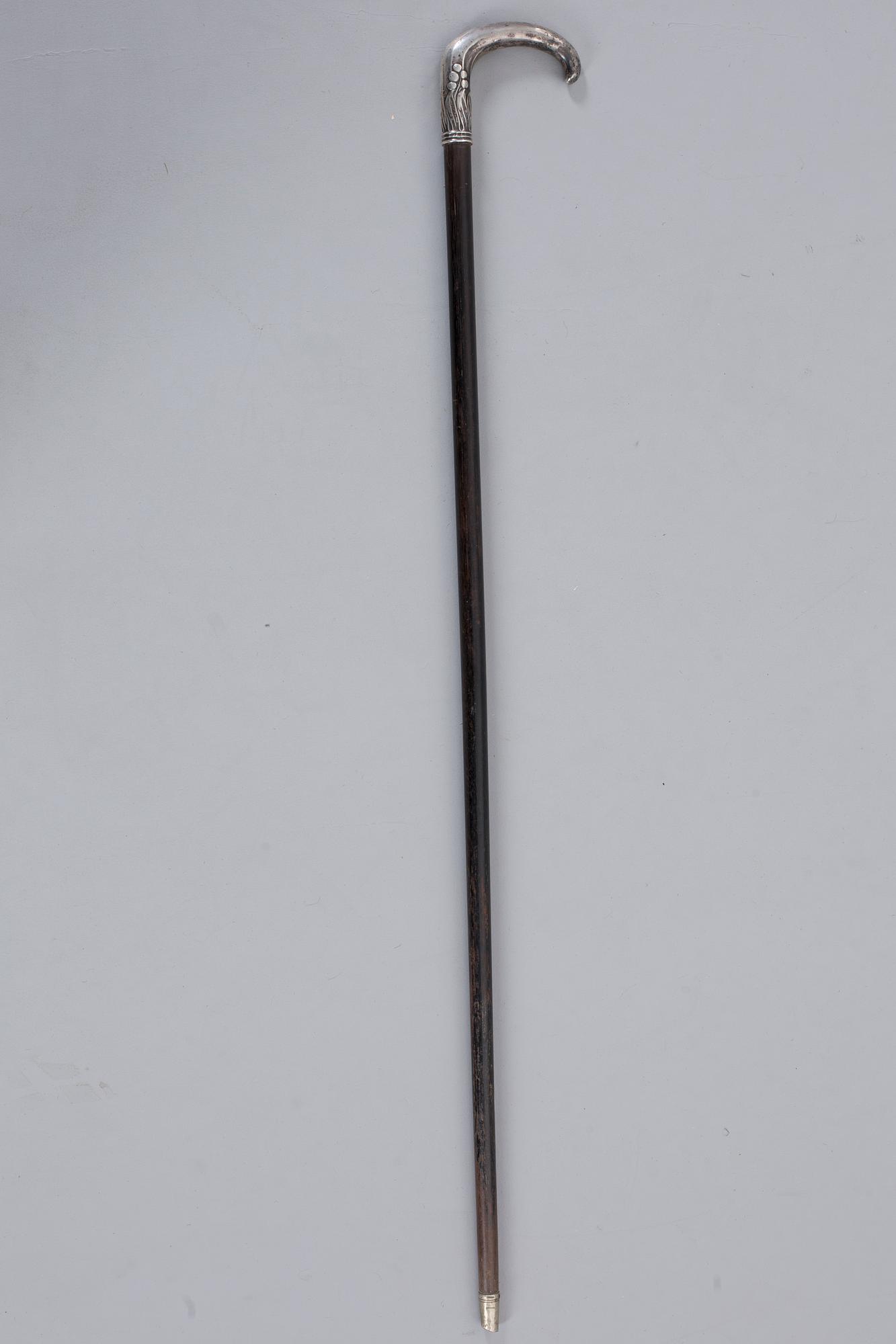 A CANE WITH SILVER MOUNTING, 1910.