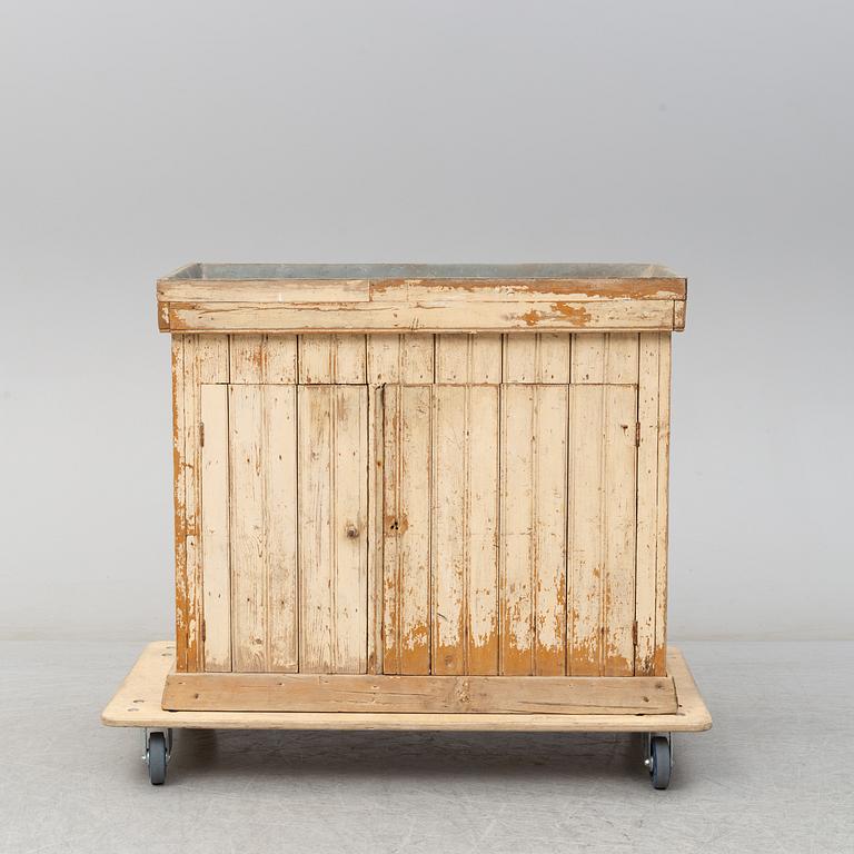 A late 19th Century cabinet with zink top.