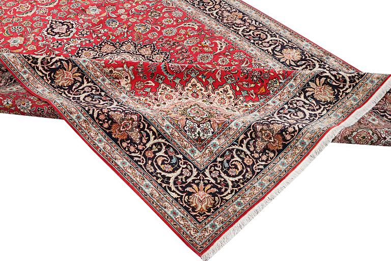 A Tabriz carpet, part silk, 50 raj, c. 325 x 208 cm.