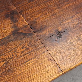 An oak dining table, Baroque early 18th century and Baroque style 19th/20th century.