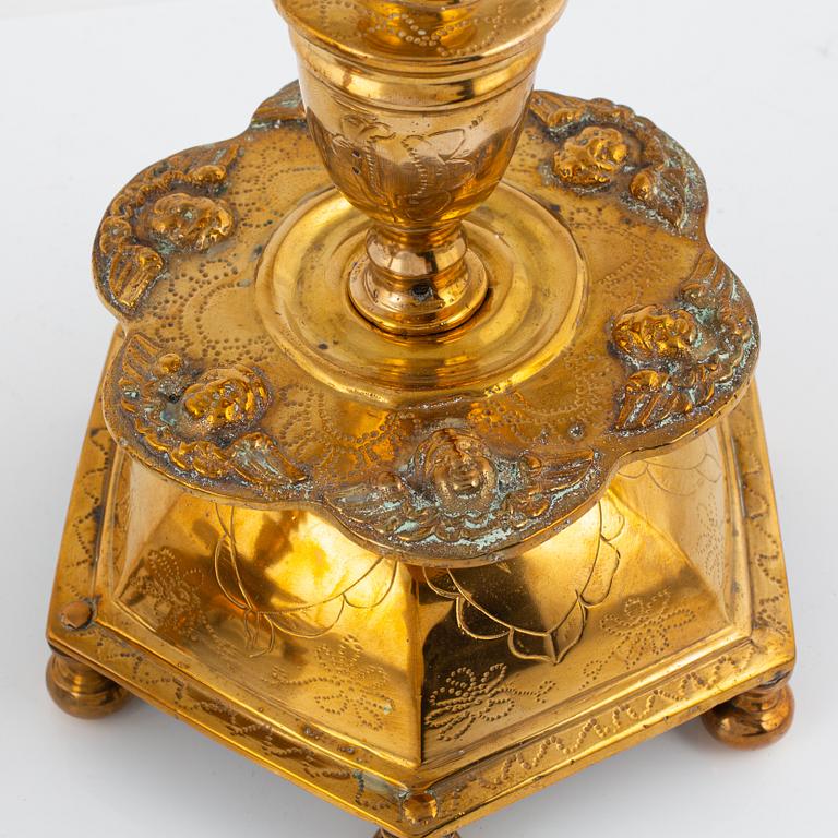 A pair of brass barock style candlesticks.