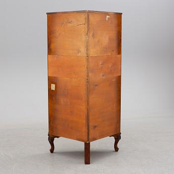 a mahogany corner cabinet.