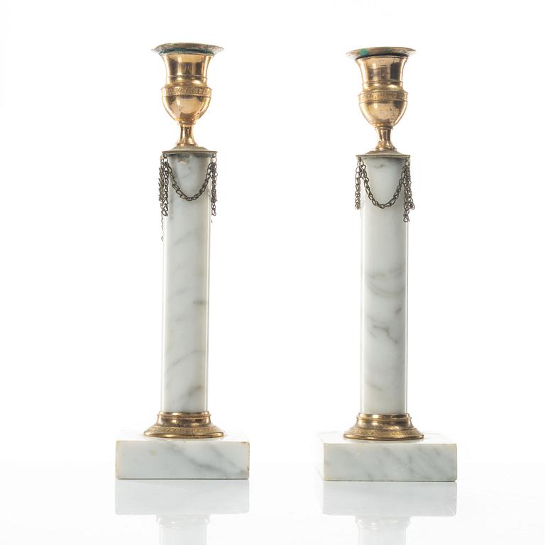 A pair of gilt-brass and marble late Gustavians candlesticks, late 18th century.