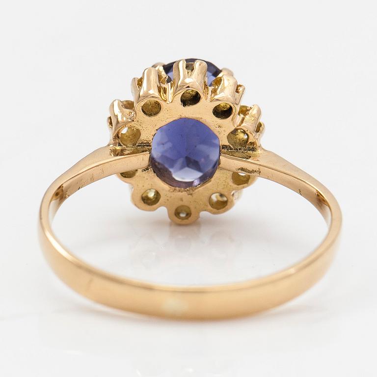 An 18K gold ring with a tanzanite and yellow sapphires.
