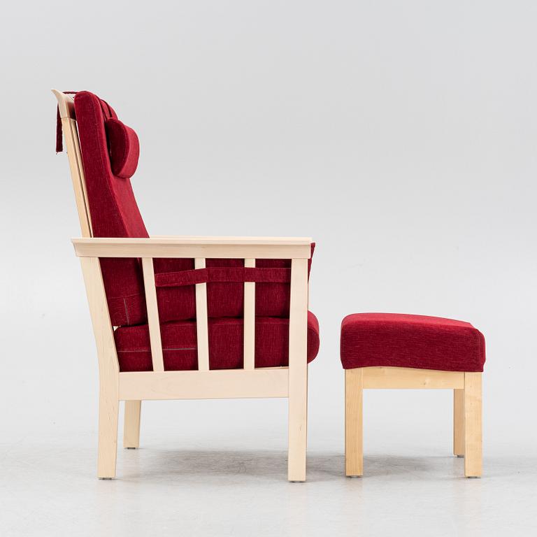 A "Sundborn" easy chair with stool, from Albin I Hyssna.