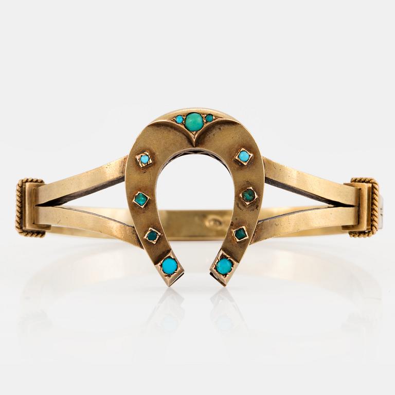 A 14K gold horse shoe bangle set with turquoises.