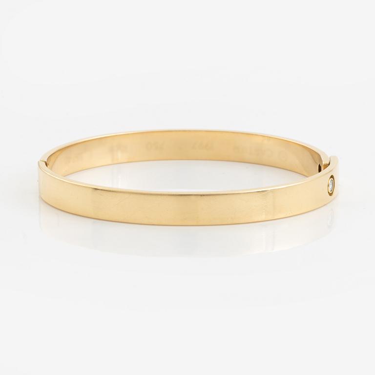 Cartier armband 18K guld med en rund briljantslipad  diamant "Anniversary Bracelet".