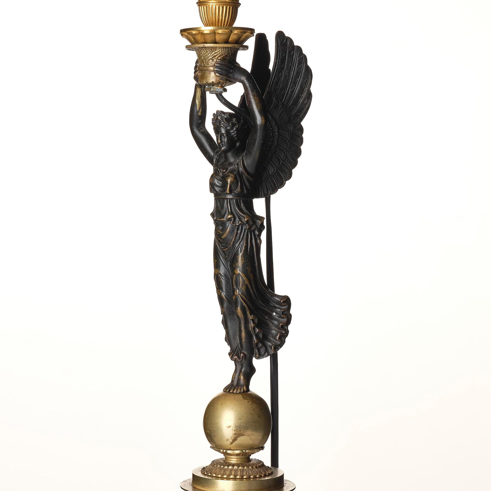A French Empire ormolu and patinated bronze table lamp, early 19th century.