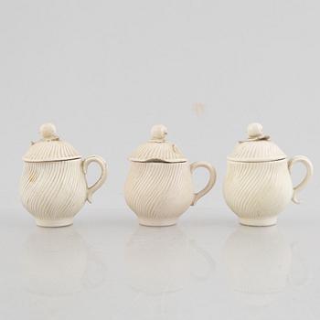 A set of six soft-paste porcelain custard cups with covers, 18th century.