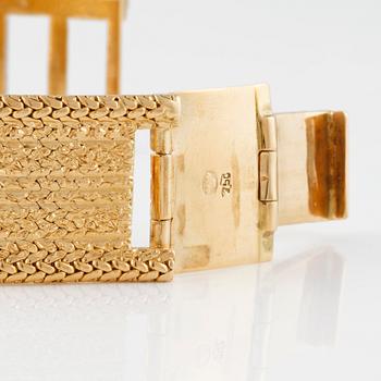 ARMLÄNK, 18K guld med fasettslipad vit syntetisk spinell, importstämplad. Vikt 68,9 gram.