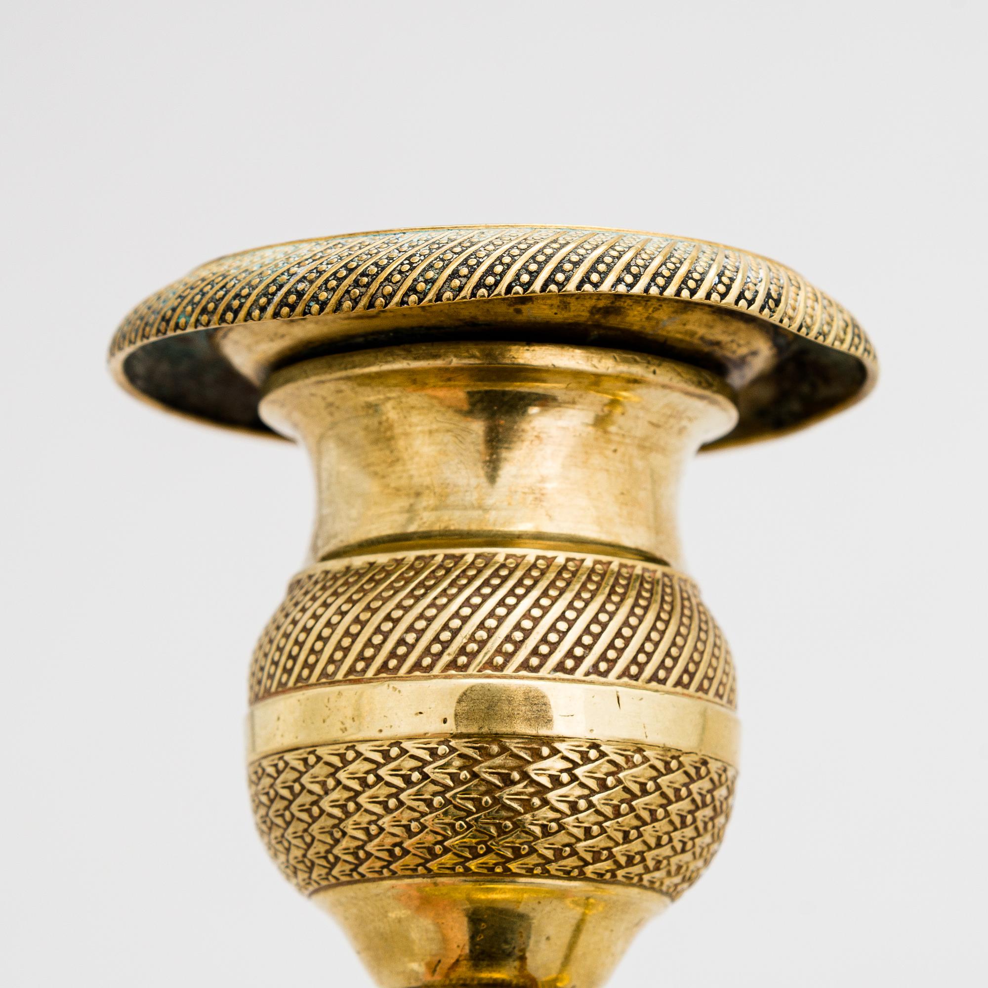 A pair of Empire bronze candlesticks from the first half of the 19th century.