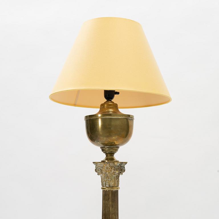 A brass floor lamp, circa 1900.