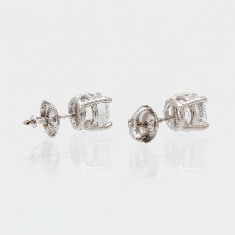 A pair of 14K white gold earrings set with round brilliant-cut diamonds.