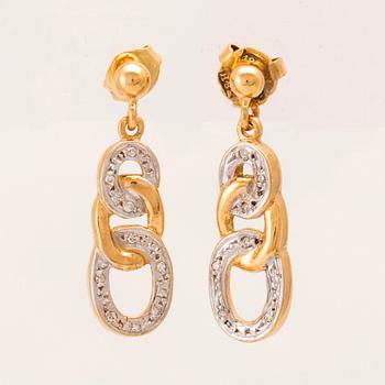 A pair of 18K white and red gold earrings set with round single-cut diamonds.