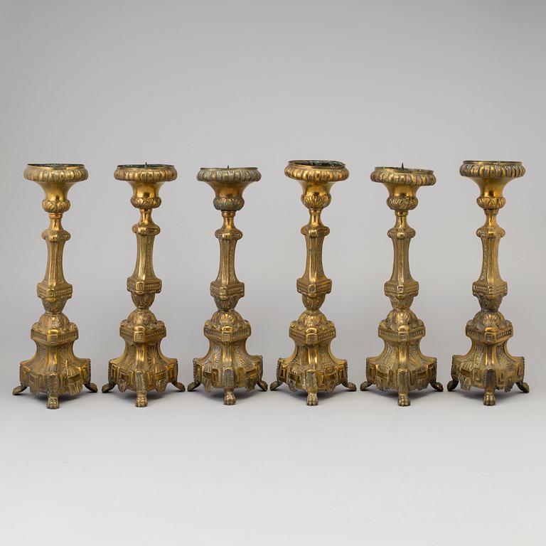 Six late 18th century brass candlesticks.