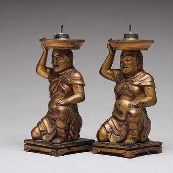 A pair of gilt lacquered candle holders, late Qing dynasty.