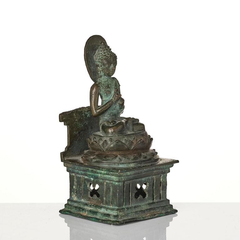 A bronze Buddha Vairocana, Eastern Java, 10th century.