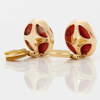 A pair of 18K gold earrings set with coral and round brilliant-cut diamonds.