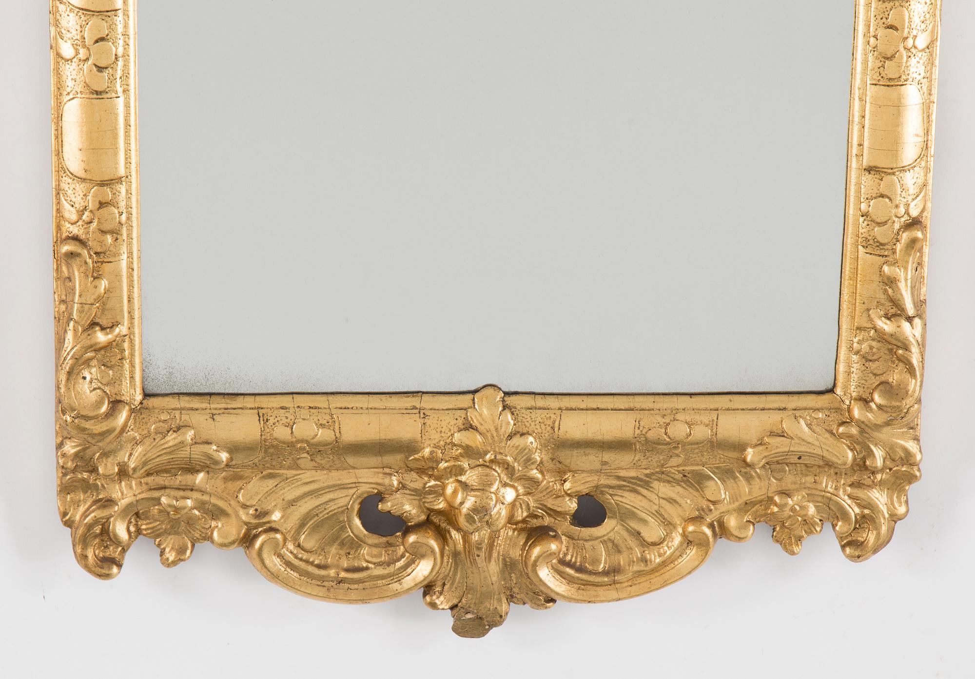 A Rococo mirror, 18th century.