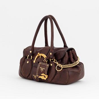 Prada, a brown leather bag.