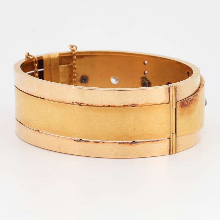 An 18K gold bracelet set with old-cut diamonds.