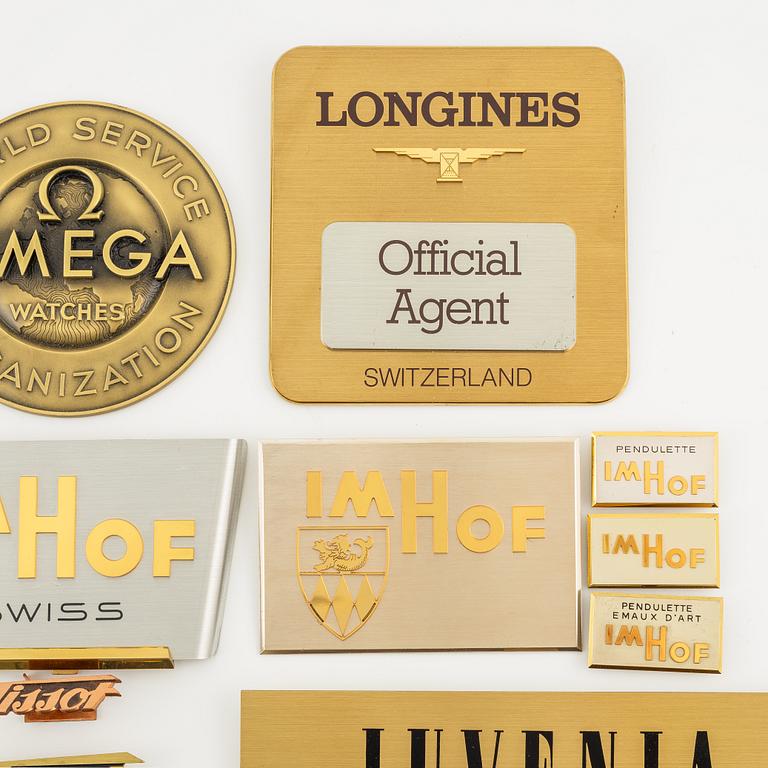 A collection of shop signs and agent plaques from Swiss watchmakers.