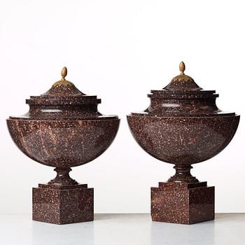 A pair of late Gustavian early 19th century porphyry urns with cover.