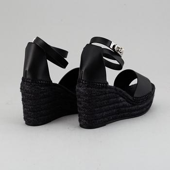HERMÈS, a pair of black leather 'Tivoli' wedge sandals, 2019, size 38.
