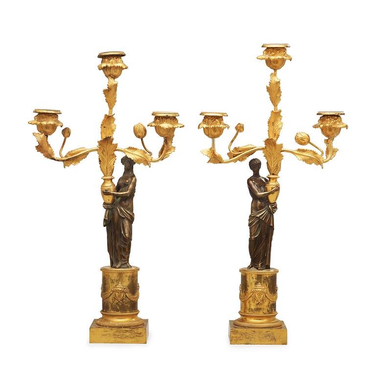 A pair of Louis XVI circa 1800 three-light candelabra.