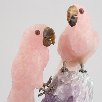 Sculpture, carved stone, birds on a quartz cliff.