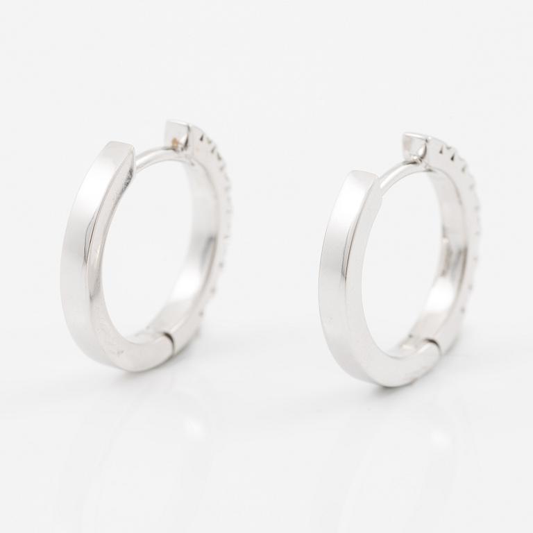 A pair of earrings in 18K white gold set with flander cut diamonds.