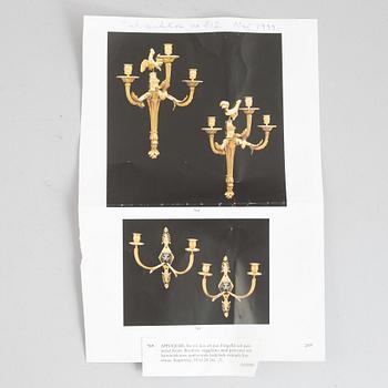 A pair of Empire-style two-branch patinated and gilt bronze appliques, 20th century incorporating older elements.