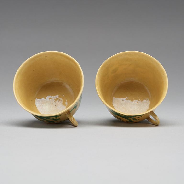 A pair of yellow glazed tea cups with stands, Qing dynasty with Guangxus six character mark (1875-1908).