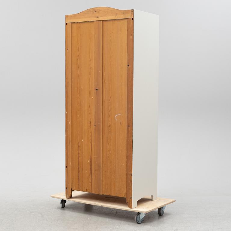 An early 20th Century painted clothes cabinet.
