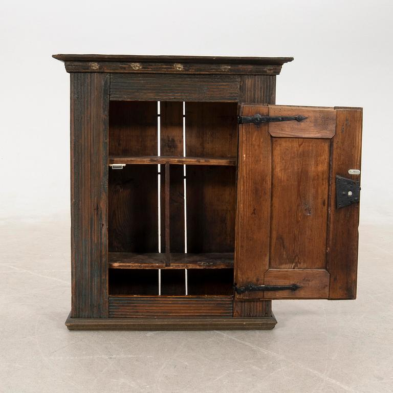 Wall-mounted cabinet dated 1804.