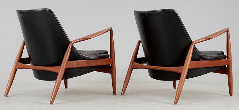 A pair of Ib Kofod Larsen 'Sälen' teak and black leather easy chairs by Olof Person, Jönköping, Sweden.