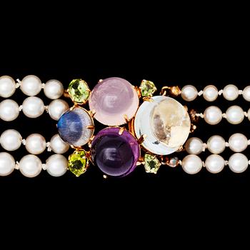 1312. COLLIER, fyra rader odlade pärlor, 7,2-5,2 mm, spänne med cabochonslipad ametist, rosenkvarts och akvamarin. 1960-tal.