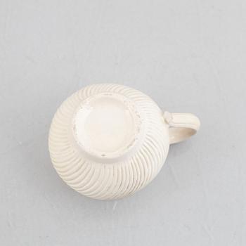 A set of six soft-paste porcelain custard cups with covers, 18th century.